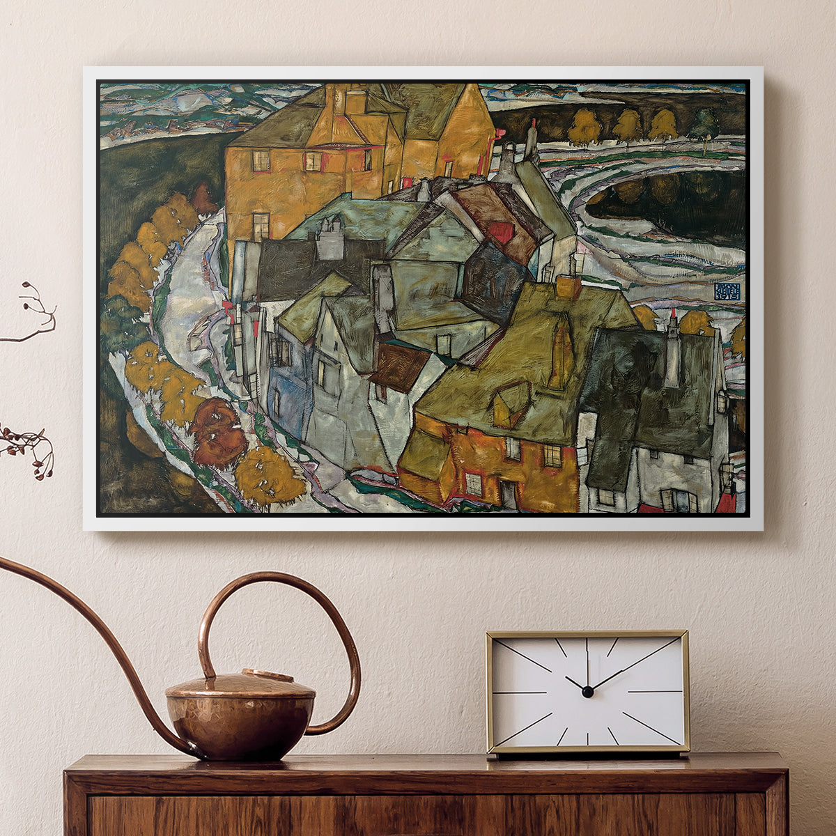 White floater framed canvas featuring an expressionist depiction of island town with geometric forms, displayed above a cabinet in a soft-toned living room.