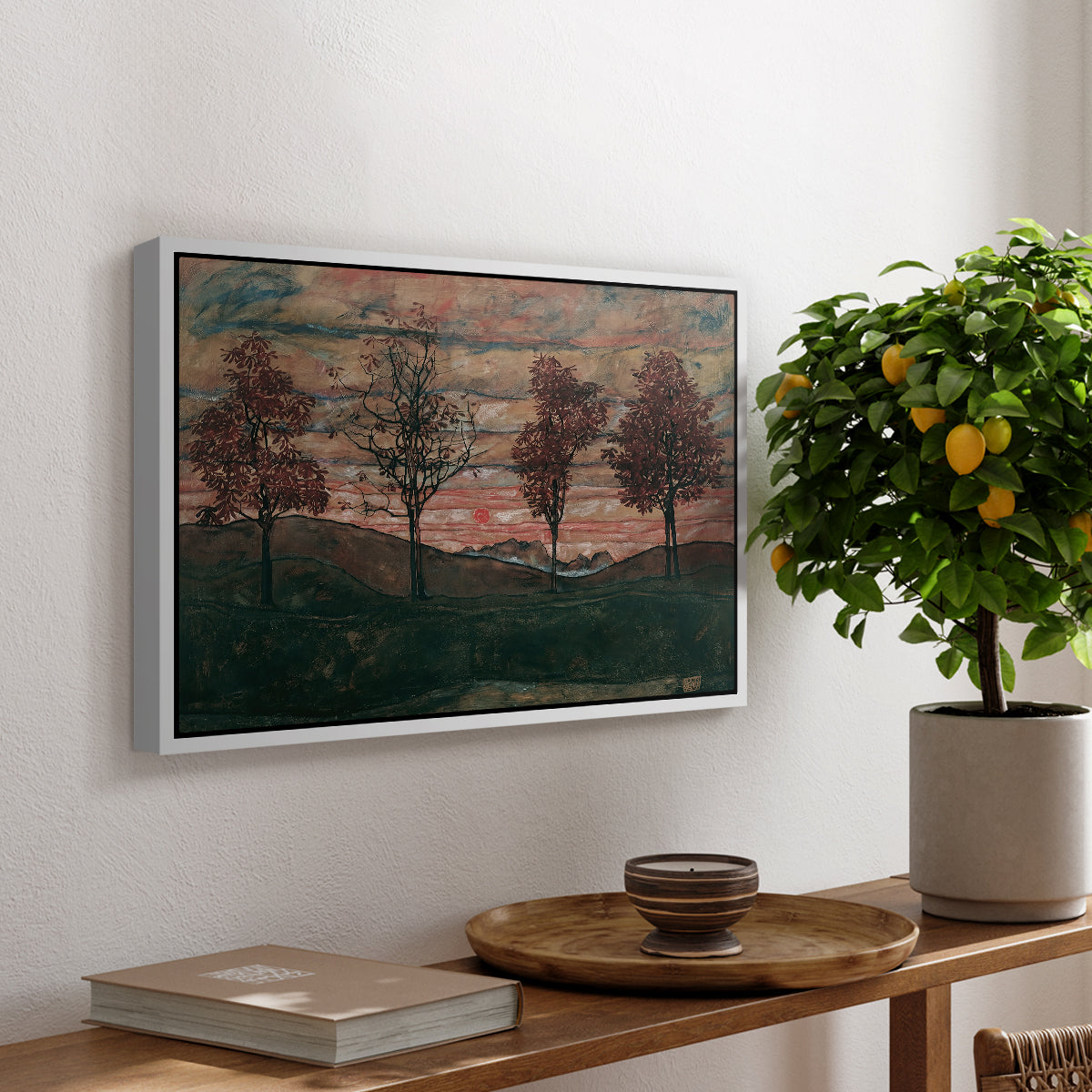 Four Trees, 1917 by Egon Schiele, presented in a white floater framed canvas featuring four trees standing in open landscape against colorful sky, displayed above a hallway console table.