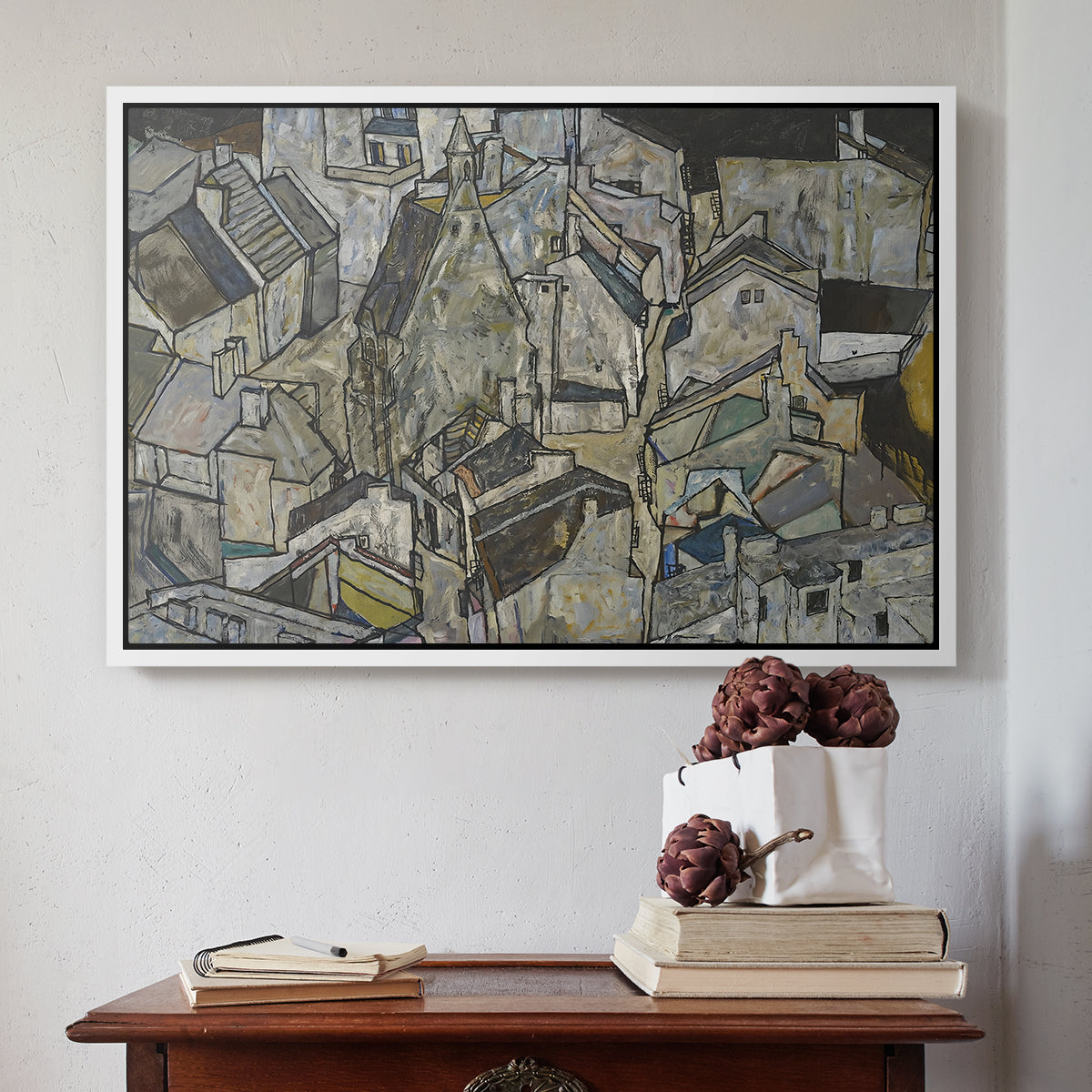 White floater framed canvas featuring Mödling II, 1918 by Egon Schiele above an entryway table in a minimalist foyer.