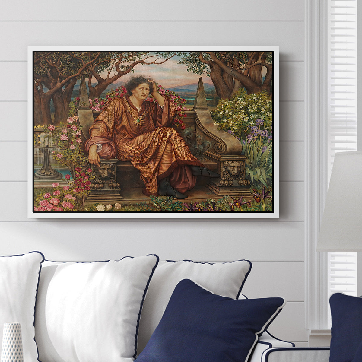 A Soul in Hell, c. 1901-1902 by Evelyn De Morgan displayed above a sofa in a living room in a white floater frame, featuring a dramatic allegory of suffering with figure engulfed in fiery environment.