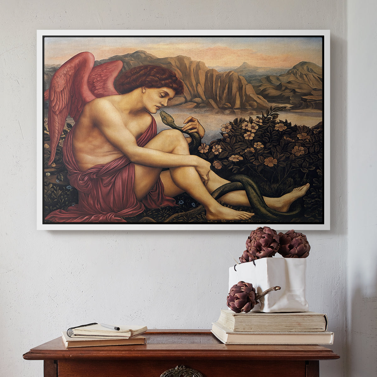 White floater framed canvas featuring The Angel with the Serpent, c. 1870-1875 by Evelyn De Morgan above an entryway table in a minimalist foyer.