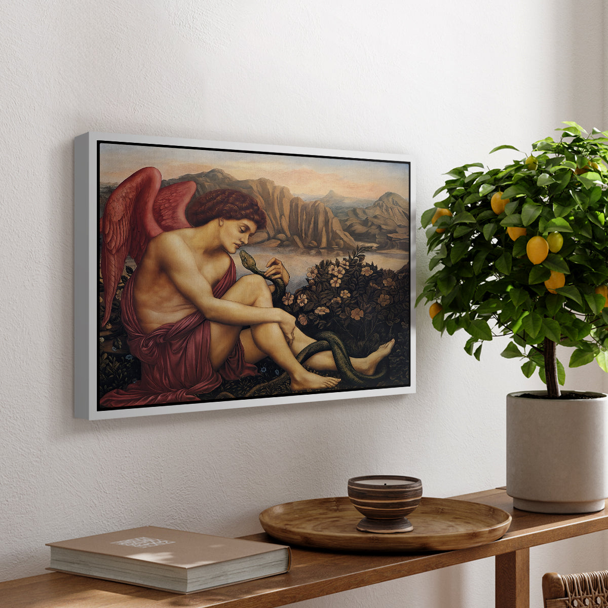 The Angel with the Serpent, c. 1870-1875 by Evelyn De Morgan, presented in a white floater framed canvas featuring an angelic figure confronting serpent in symbolic battle of good and evil, displayed above a hallway console table.