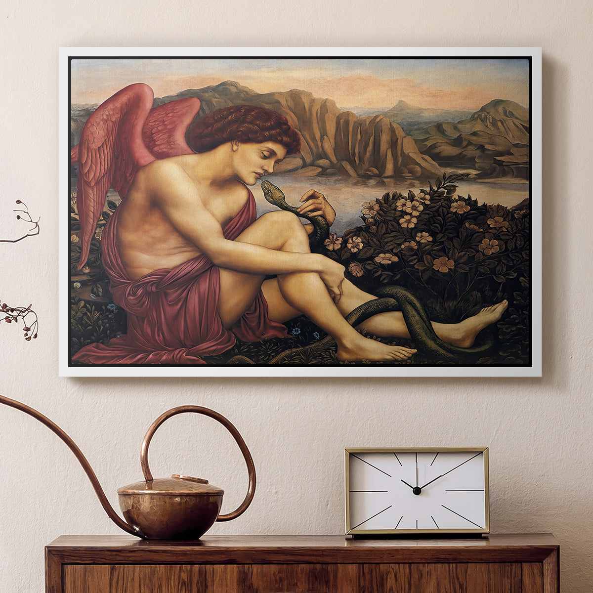 White floater framed canvas featuring a religious scene with angel defeating snake in dramatic pose, displayed above a cabinet in a soft-toned living room.
