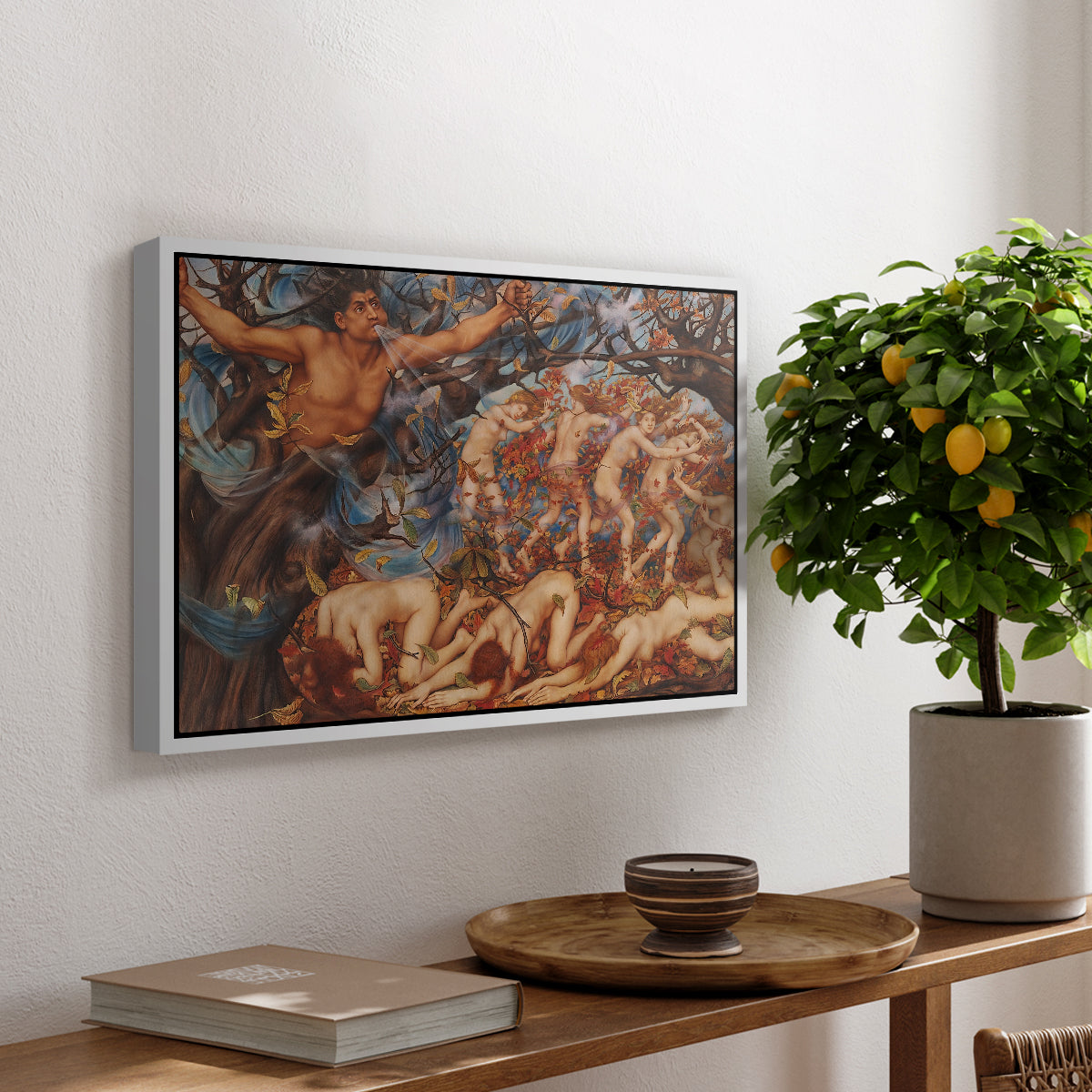 Boreas and the Fallen Leaves, c. 1910-1914 by Evelyn De Morgan, presented in a white floater framed canvas featuring swirling figures carried by wind among falling leaves in dynamic composition, displayed above a hallway console table.