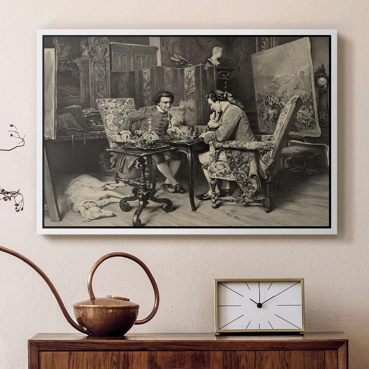 White floater framed canvas featuring an intimate interior with players focused on board and pieces, displayed above a cabinet in a soft-toned living room.