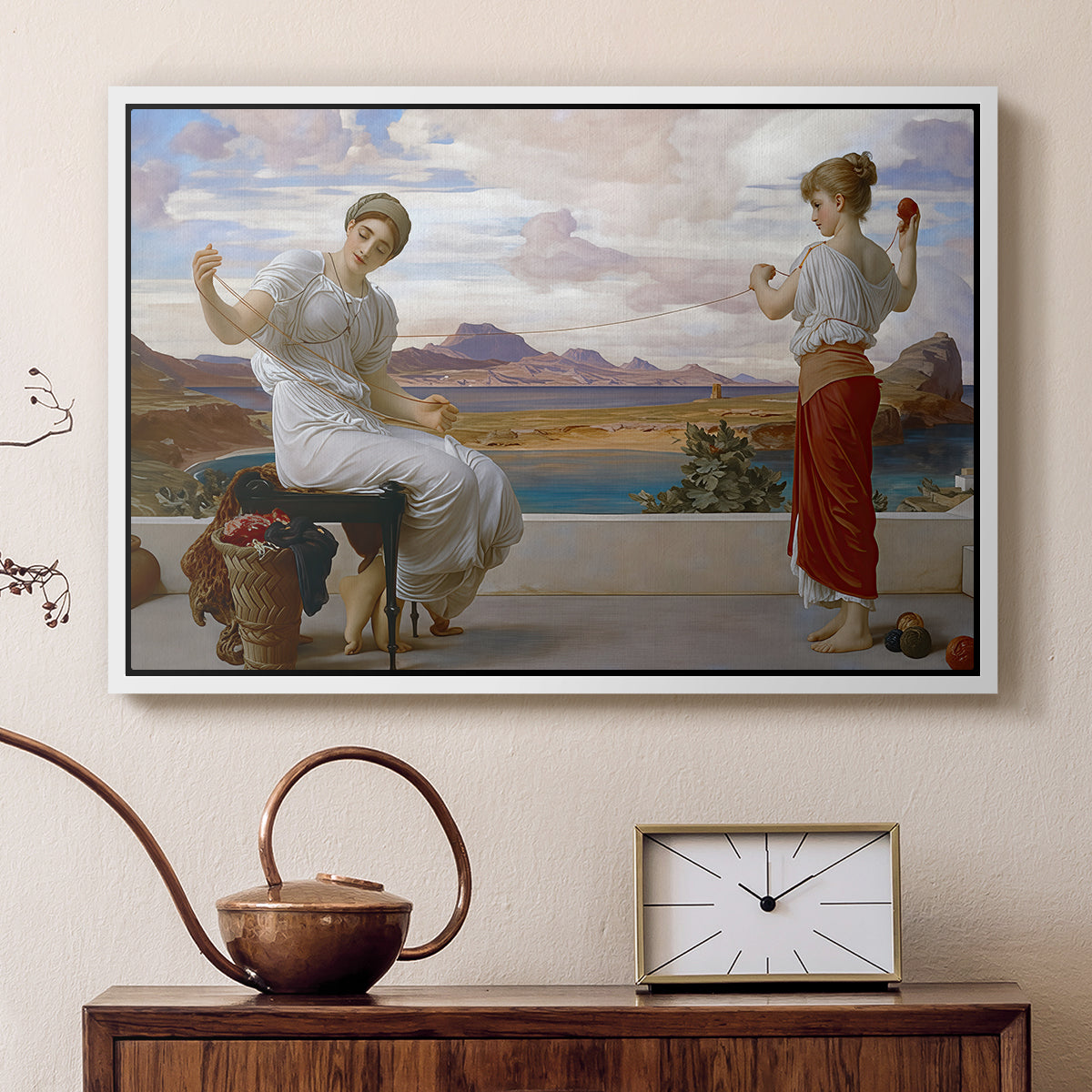 White floater framed canvas featuring a classical scene of figures winding thread together, displayed above a cabinet in a soft-toned living room.