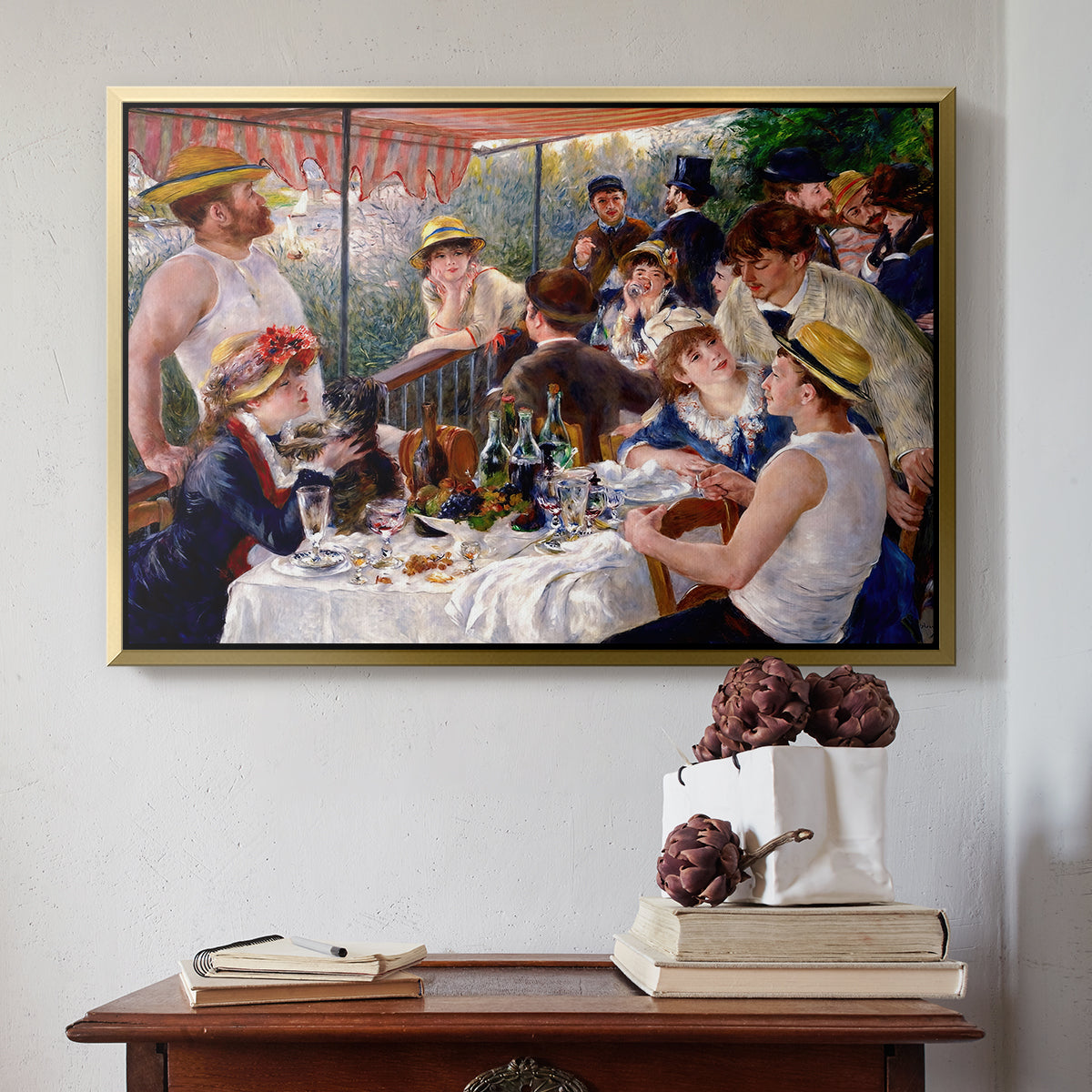 Gold floater framed canvas featuring Luncheon of the Boating Party (Le Déjeuner des canotiers), 1880-1881 by Pierre-Auguste Renoir above an entryway table in a minimalist foyer.