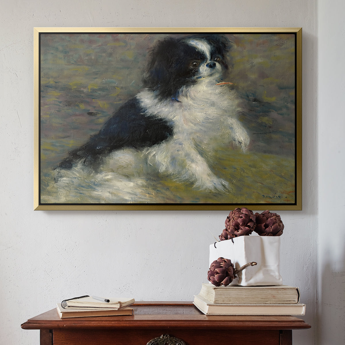 Gold floater framed canvas featuring Tama, the Japanese Dog, c. 1876 by Pierre-Auguste Renoir above an entryway table in a minimalist foyer.
