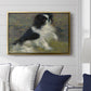 Tama, the Japanese Dog, c. 1876 by Pierre-Auguste Renoir displayed above a sofa in a living room in a gold floater frame, featuring an impressionist painting of a dog wading through water with blurred background.