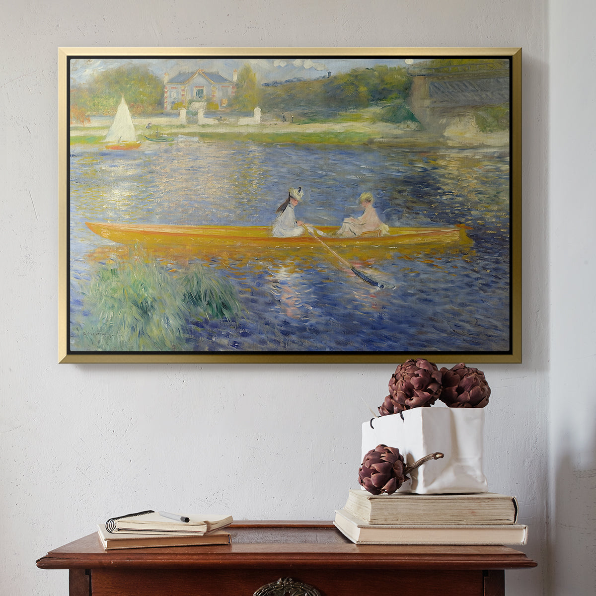 Gold floater framed canvas featuring The Skiff (La Yole), 1875 by Pierre-Auguste Renoir above an entryway table in a minimalist foyer.