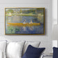 The Skiff (La Yole), 1875 by Pierre-Auguste Renoir displayed above a sofa in a living room in a gold floater frame, featuring an impressionist boating scene with people relaxing in a narrow skiff.