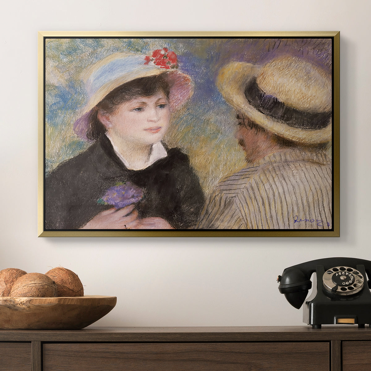 Boating Couple (Aline Charigot and Renoir), c. 1881 by Pierre-Auguste Renoir in a gold floater framed canvas displayed above a console table in a hallway, featuring a romantic scene of two figures in casual conversation with soft light.