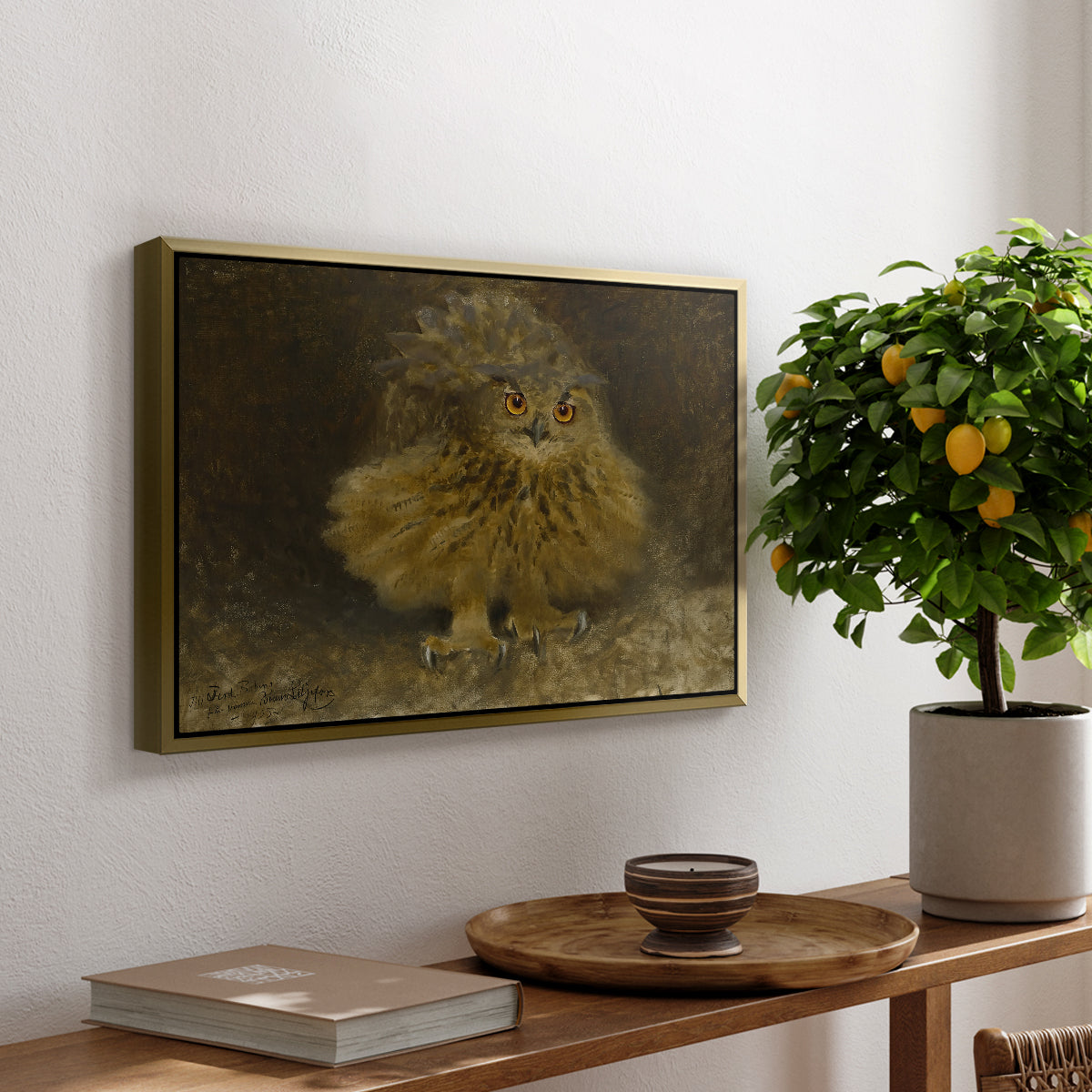 An Eagle Owl (Berguv), 1905 by Bruno Liljefors, presented in a gold floater framed canvas featuring a large owl perched on branch in shadowy natural forest setting, displayed above a hallway console table.