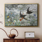 Gold floater framed canvas featuring a multiple birds flying together in natural outdoor scene, displayed above a cabinet in a soft-toned living room.