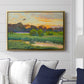 Flying Duck at Sunset, 1924 by Bruno Liljefors displayed above a sofa in a living room in a gold floater frame, featuring a lone duck soaring over a glowing marshland.