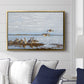 Greylag Geese (Grågäss), 1922 by Bruno Liljefors displayed above a sofa in a living room in a gold floater frame, featuring birds standing and resting along shoreline with soft grass and water.