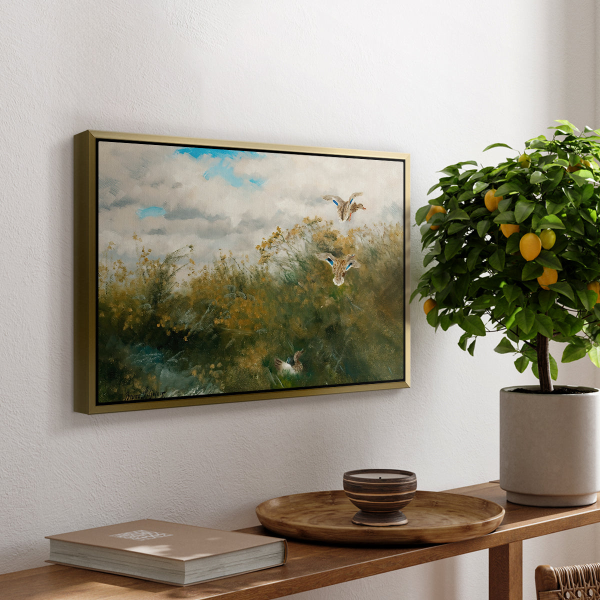Wild Ducks (Grasänder), 1890 by Bruno Liljefors, presented in a gold floater framed canvas featuring ducks moving through grassy wetland near water's edge, displayed above a hallway console table.