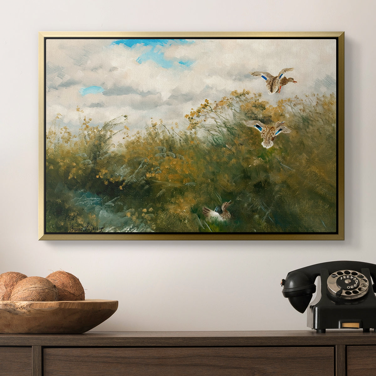 Wild Ducks (Grasänder), 1890 by Bruno Liljefors in a gold floater framed canvas displayed above a console table in a hallway, featuring a realistic depiction of ducks in countryside landscape.
