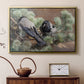 Gold floater framed canvas featuring a realistic scene of crows interacting on grassy terrain, displayed above a cabinet in a soft-toned living room.