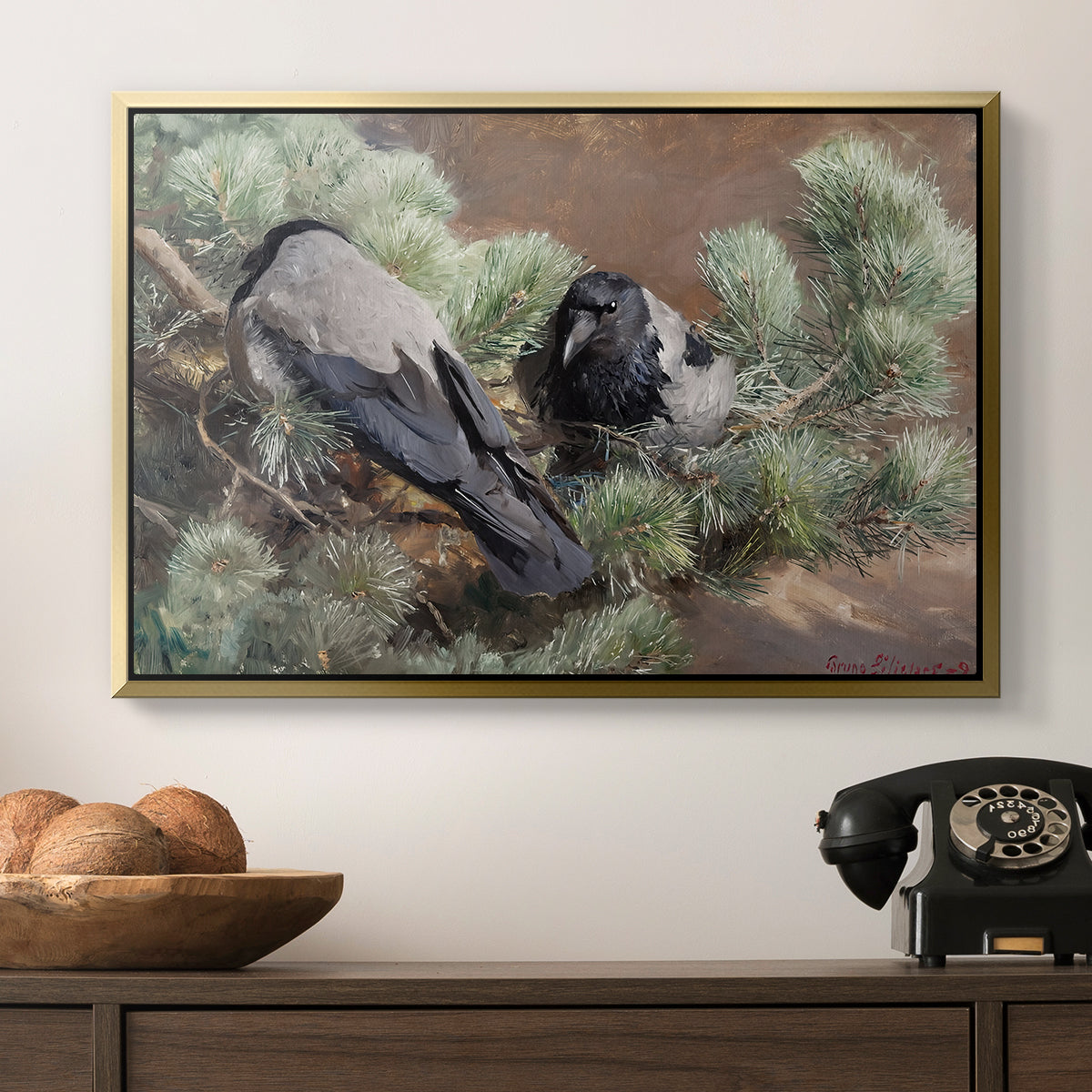 Hooded Crows (Kråkor), 1891 by Bruno Liljefors in a gold floater framed canvas displayed above a console table in a hallway, featuring a wildlife painting of dark birds against muted landscape.