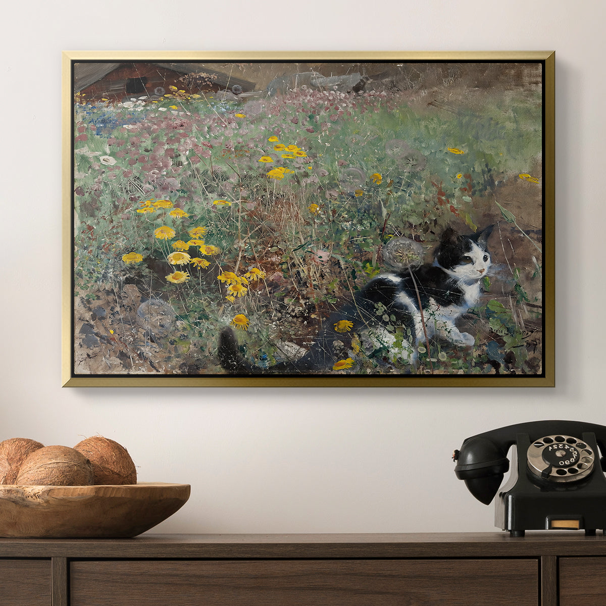 Cat on a Flowery Meadow, 1887 by Bruno Liljefors in a gold floater framed canvas displayed above a console table in a hallway, featuring a naturalistic depiction of cat in blooming countryside setting.