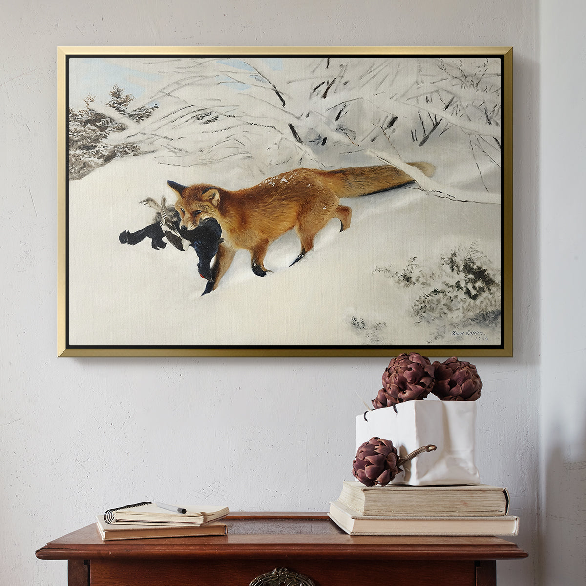 Gold floater framed canvas featuring Fox in Snow Landscape, 1900 by Bruno Liljefors above an entryway table in a minimalist foyer.