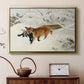 Gold floater framed canvas featuring a red fox crossing snow-covered ground under pale sky, displayed above a cabinet in a soft-toned living room.