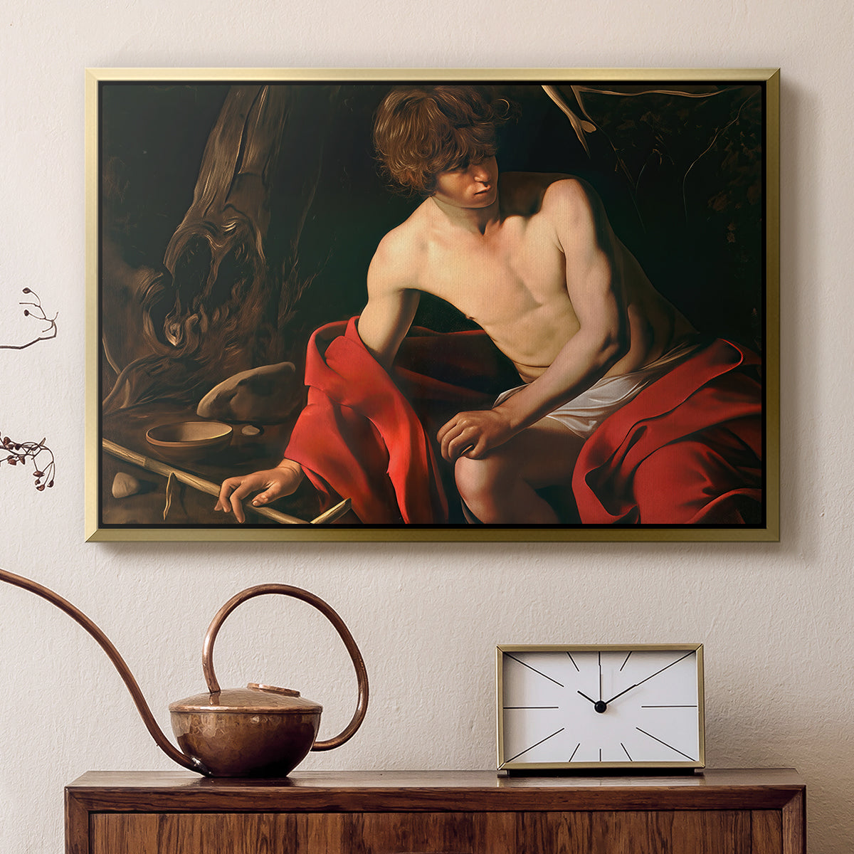 Gold floater framed canvas featuring a biblical youth seated outdoors with symbolic staff and minimal landscape, displayed above a cabinet in a soft-toned living room.