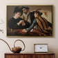 Gold floater framed canvas featuring a young men playing cards with one cheating and another watching closely, displayed above a cabinet in a soft-toned living room.