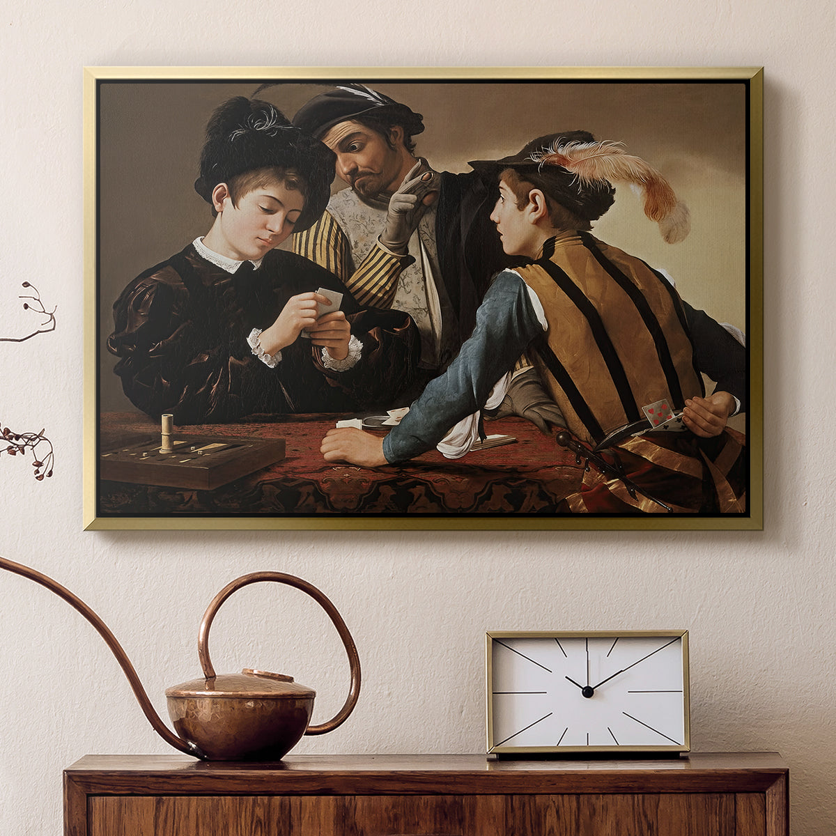 Gold floater framed canvas featuring a young men playing cards with one cheating and another watching closely, displayed above a cabinet in a soft-toned living room.