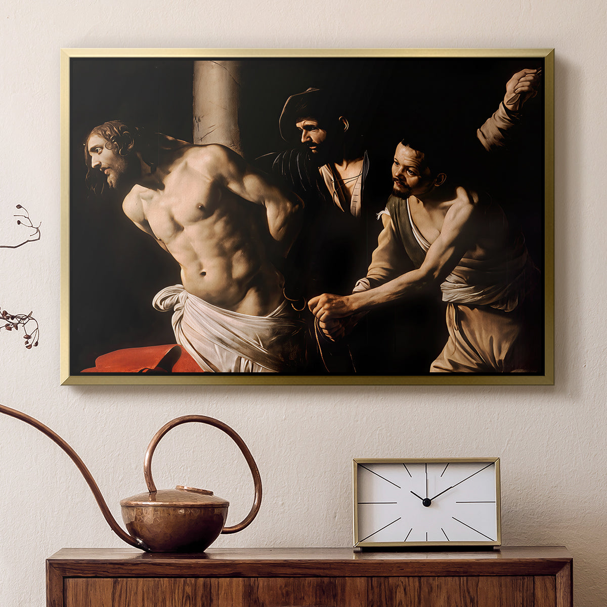 Gold floater framed canvas featuring a biblical depiction of men whipping Christ tied to pillar, displayed above a cabinet in a soft-toned living room.