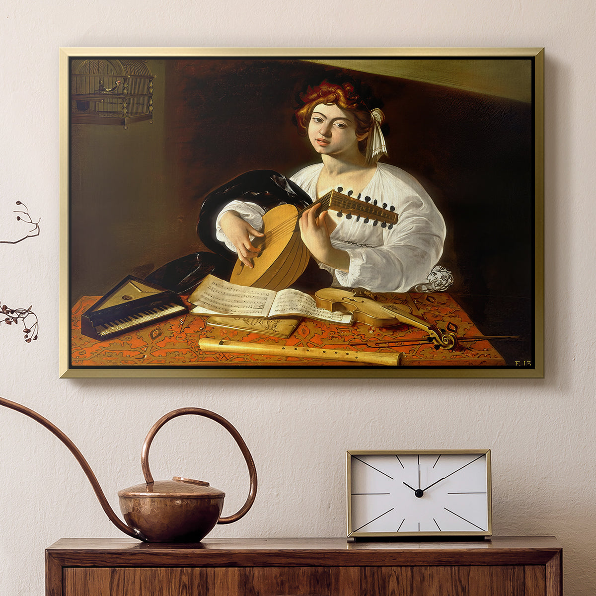 Gold floater framed canvas featuring a detailed scene of youth playing string instrument with fruit and flowers nearby, displayed above a cabinet in a soft-toned living room.