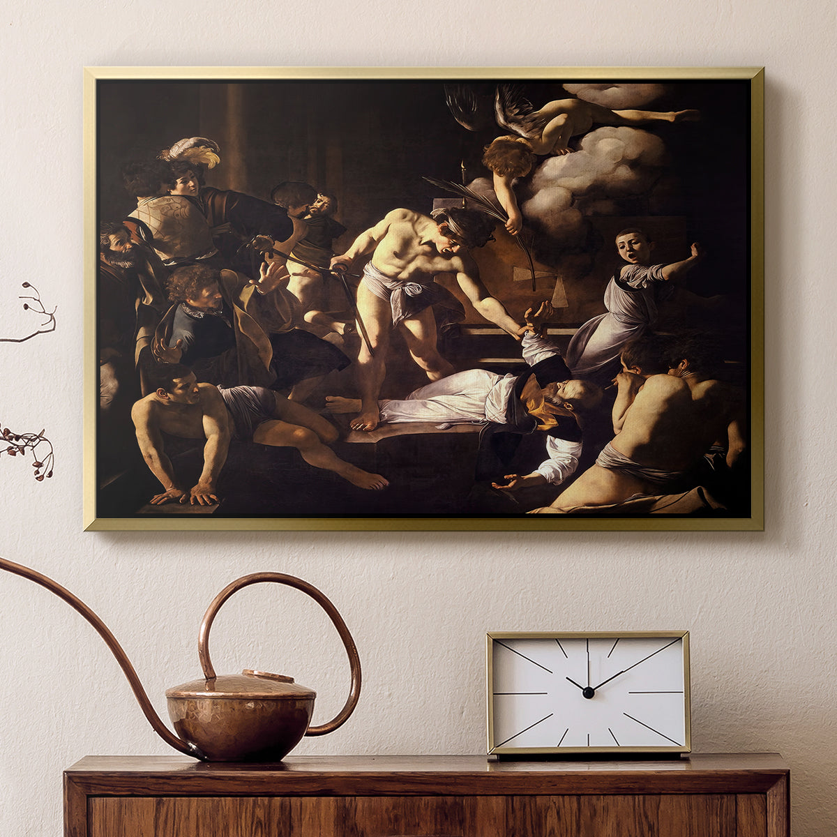 Gold floater framed canvas featuring a religious narrative showing violent attack on saint in crowded setting, displayed above a cabinet in a soft-toned living room.