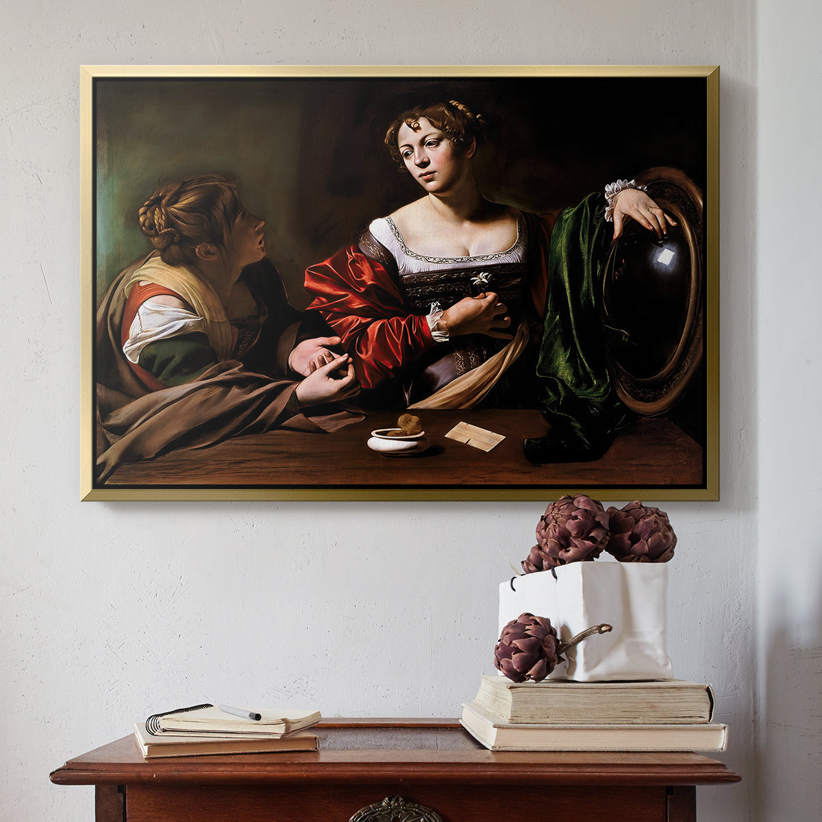 Gold floater framed canvas featuring Martha and Mary Magdalene, c. 1598 by Caravaggio above an entryway table in a minimalist foyer.