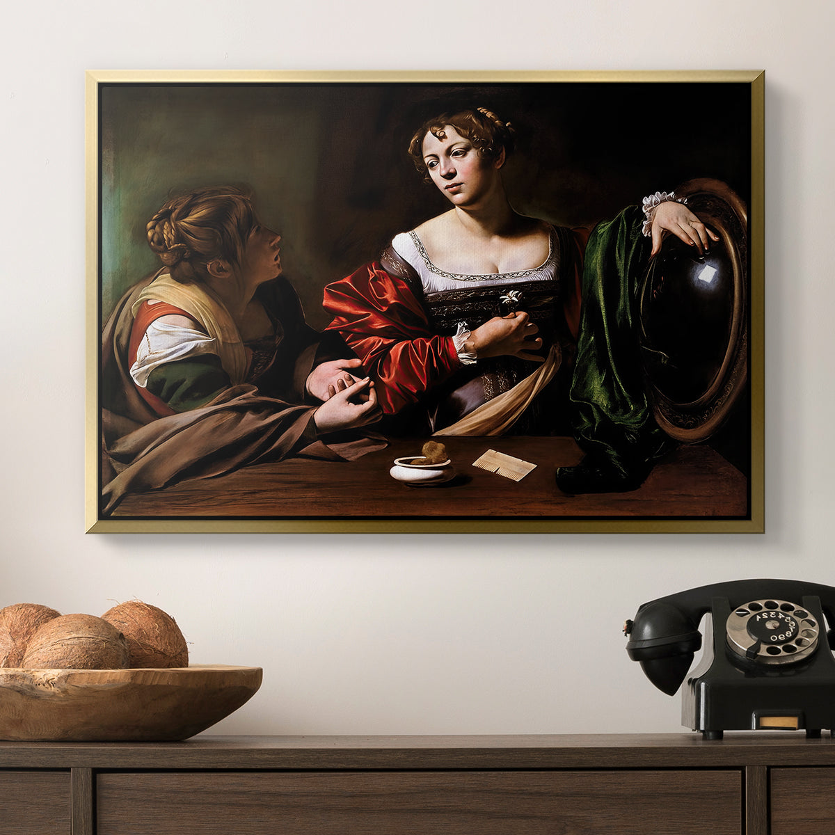 Martha and Mary Magdalene, c. 1598 by Caravaggio in a gold floater framed canvas displayed above a console table in a hallway, featuring a religious interior scene with figures engaged in thoughtful dialogue.