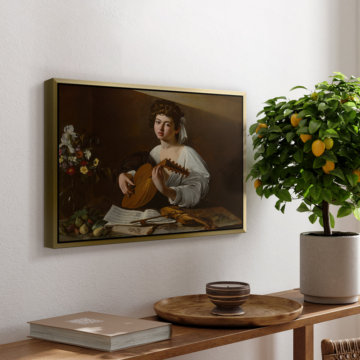 The Lute Player (Hermitage Version), c. 1596 by Caravaggio, presented in a gold floater framed canvas featuring a young musician playing lute beside table with fruit and sheet music, displayed above a hallway console table.