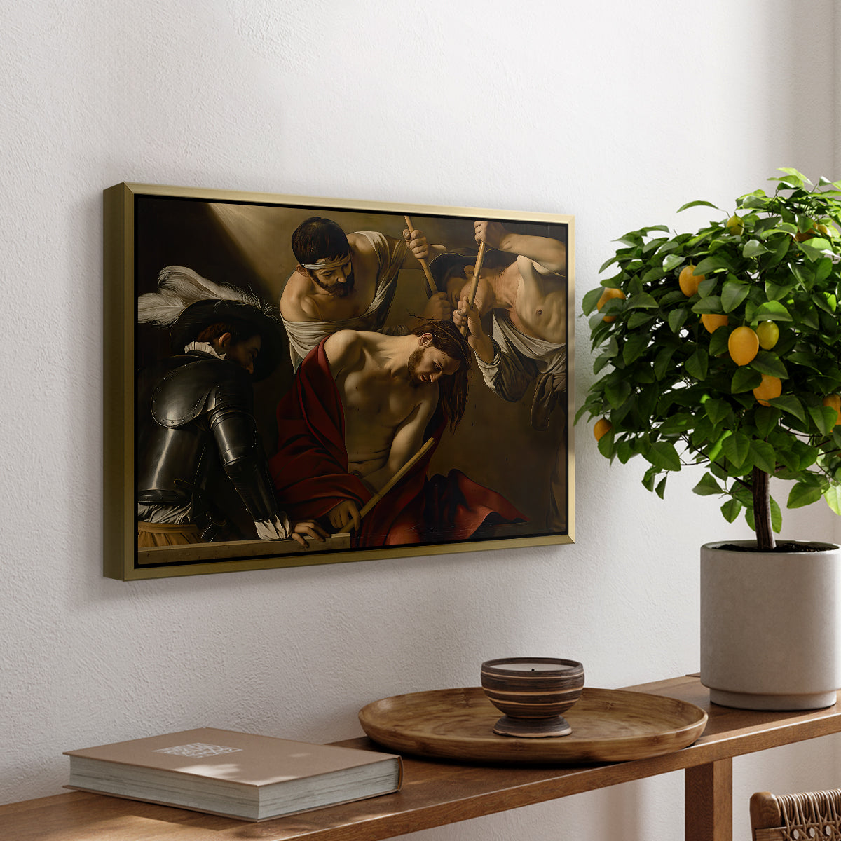 The Crowning with Thorns (Vienna Version), c. 1602-1604 by Caravaggio, presented in a gold floater framed canvas featuring Christ surrounded by men pressing crown of thorns onto his head, displayed above a hallway console table.