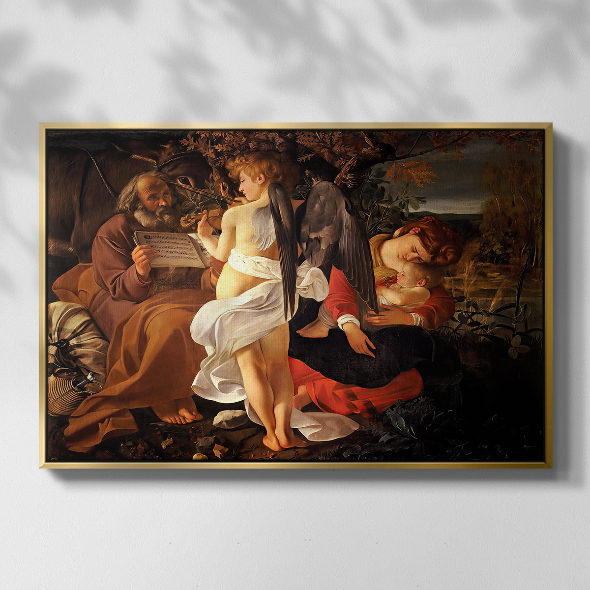 Front view of Rest on the Flight into Egypt, c. 1597 by Caravaggio in a gold floater framed canvas.