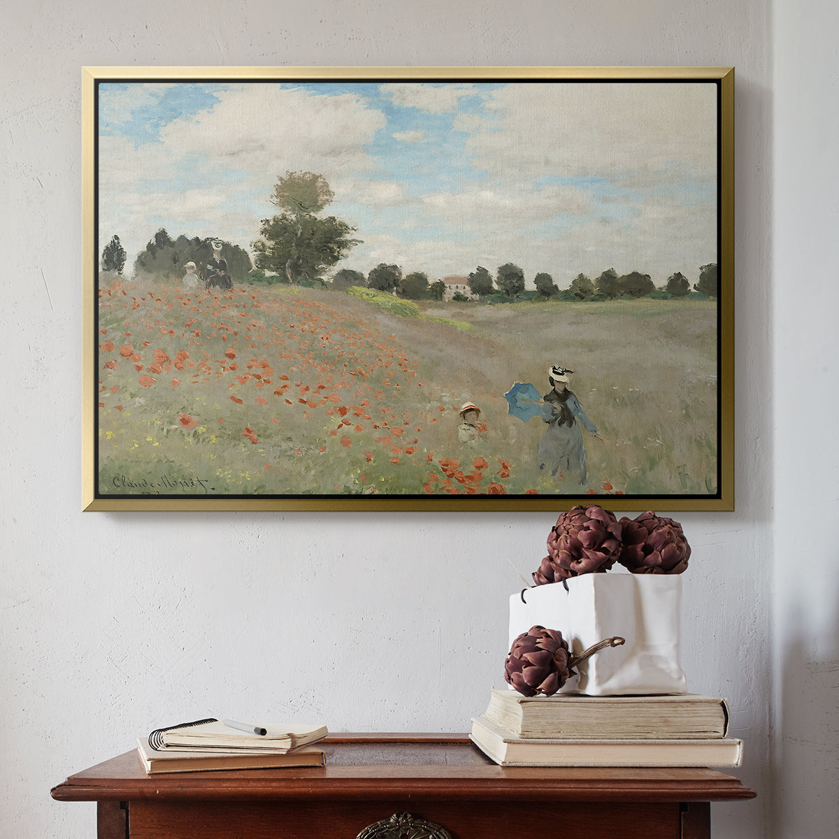 Gold floater framed canvas featuring The Poppy Field near Argenteuil, 1873 by Claude Monet above an entryway table in a minimalist foyer.