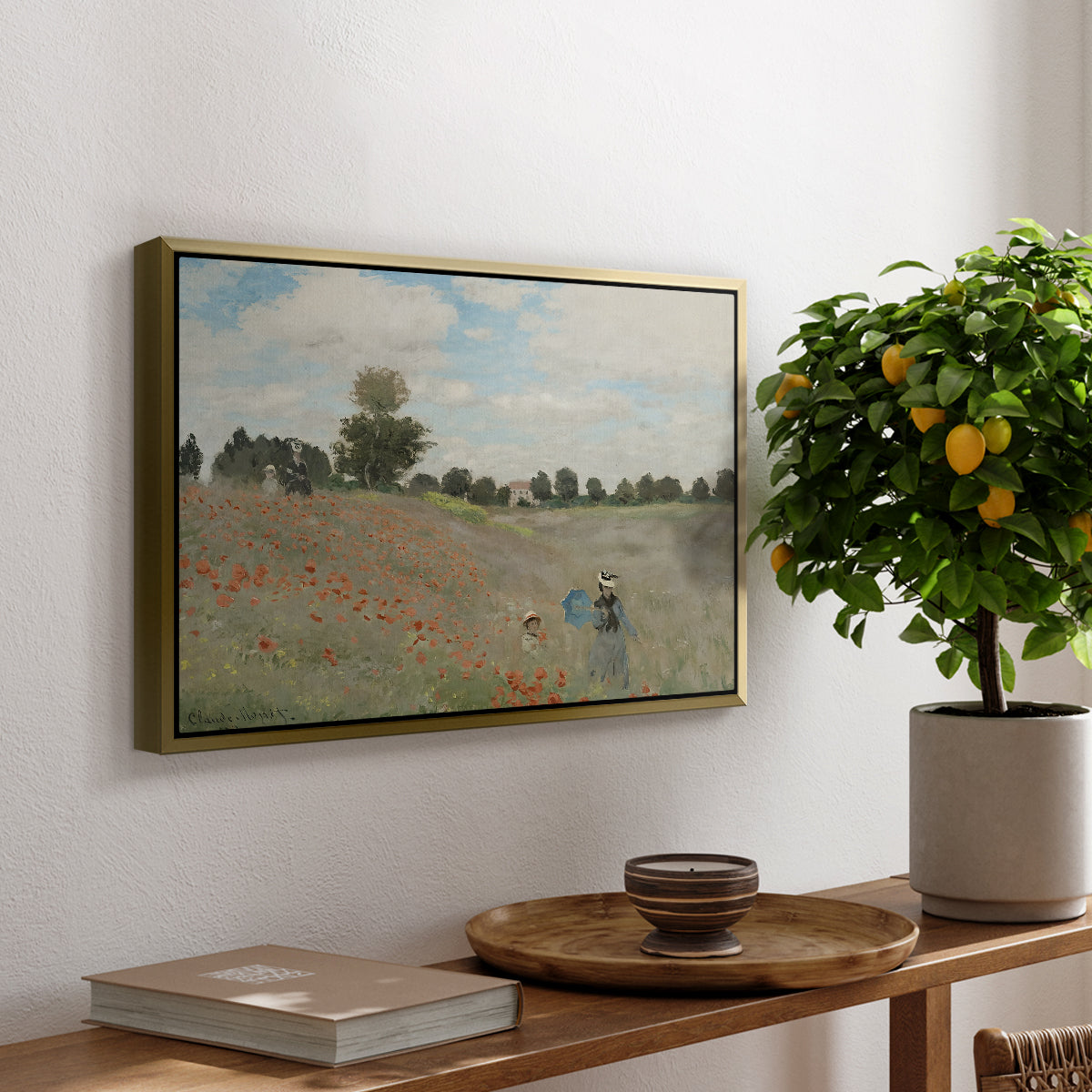 The Poppy Field near Argenteuil, 1873 by Claude Monet, presented in a gold floater framed canvas featuring a field of red poppies with figures walking across rolling landscape, displayed above a hallway console table.