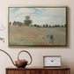 Gold floater framed canvas featuring a bright meadow filled with poppies under open sky, displayed above a cabinet in a soft-toned living room.