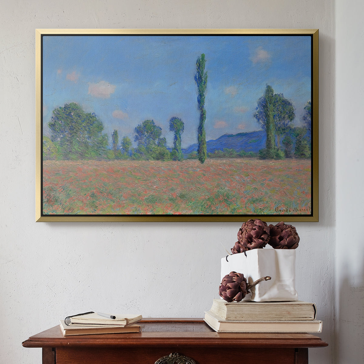 Gold floater framed canvas featuring Poppy Field (Giverny), 1890-1891 by Claude Monet above an entryway table in a minimalist foyer.