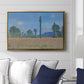 Poppy Field (Giverny), 1890-1891 by Claude Monet displayed above a sofa in a living room in a gold floater frame, featuring an impressionist landscape of blooming poppies in countryside.