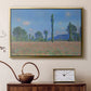 Gold floater framed canvas featuring a vibrant meadow scene with flowers and vertical tree forms, displayed above a cabinet in a soft-toned living room.