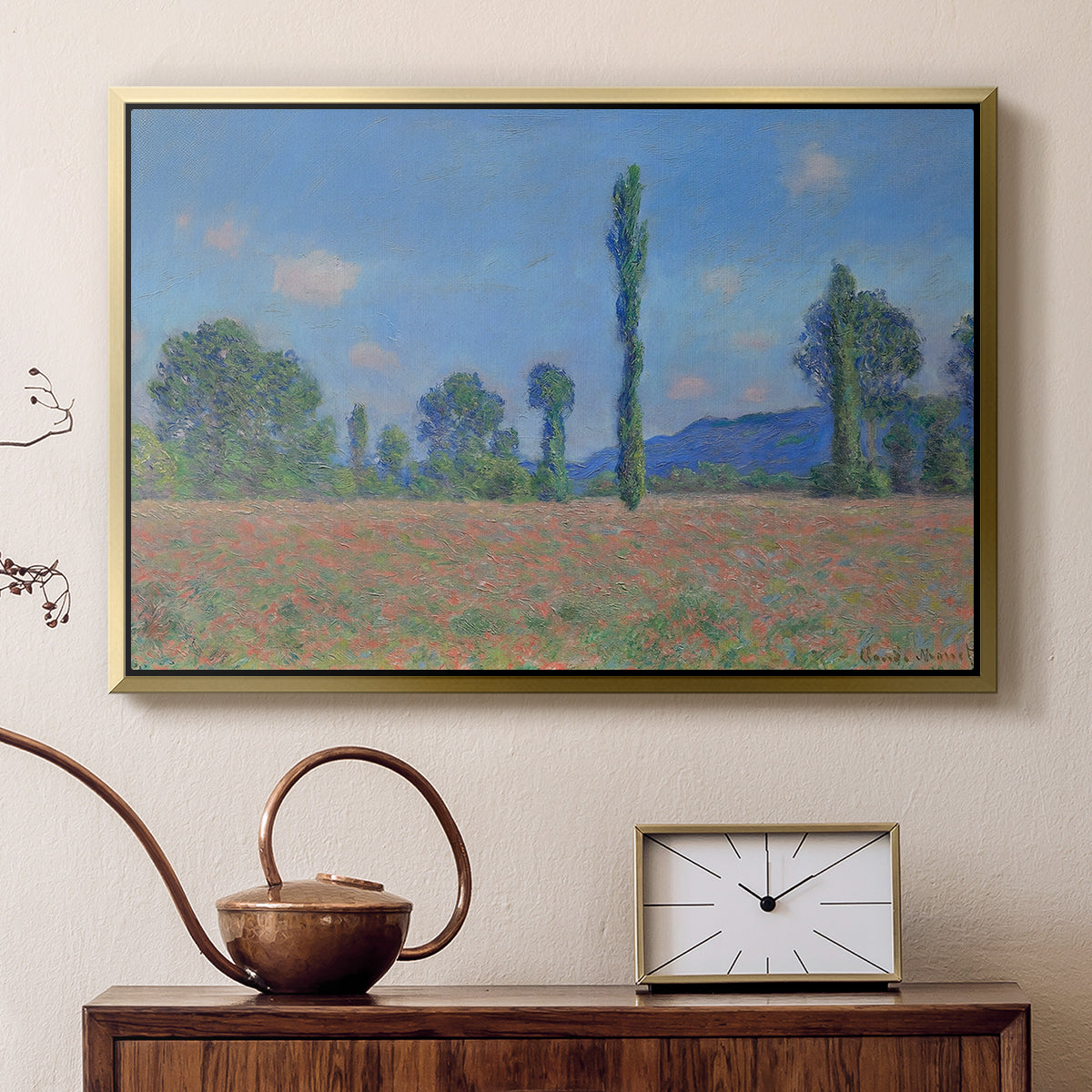 Gold floater framed canvas featuring a vibrant meadow scene with flowers and vertical tree forms, displayed above a cabinet in a soft-toned living room.