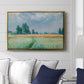 The Wheat Field (Champ de Blé), 1881 by Claude Monet displayed above a sofa in a living room in a gold floater frame, featuring an impressionist depiction of ripened grain field in countryside.