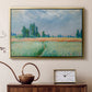 Gold floater framed canvas featuring an agricultural landscape with tall wheat and distant horizon, displayed above a cabinet in a soft-toned living room.