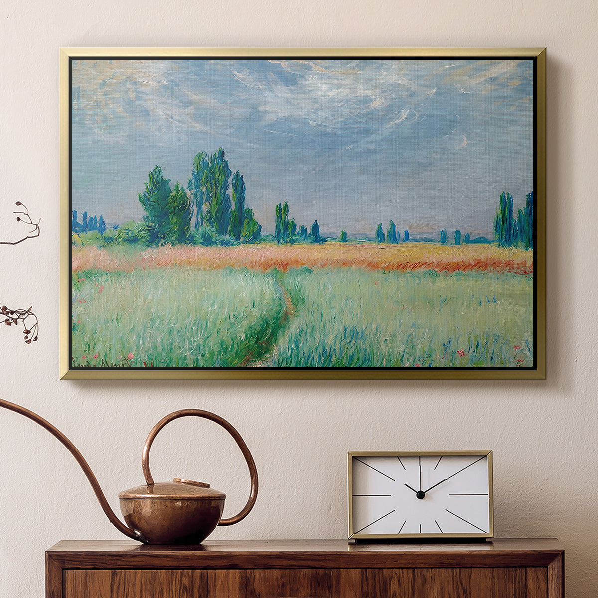 Gold floater framed canvas featuring an agricultural landscape with tall wheat and distant horizon, displayed above a cabinet in a soft-toned living room.