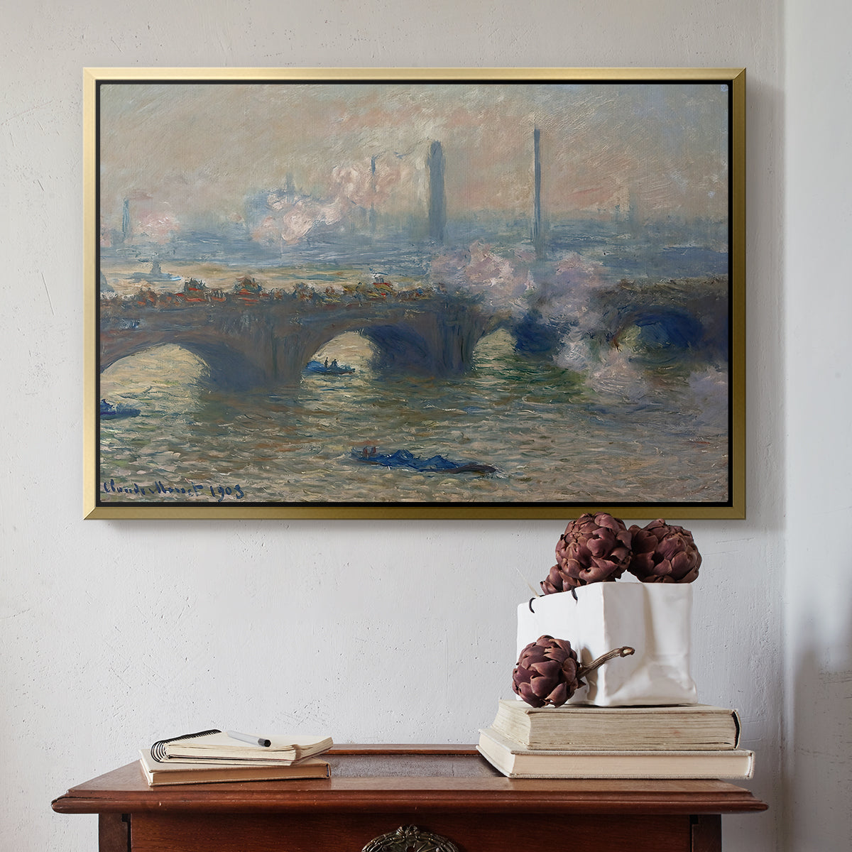 Gold floater framed canvas featuring Waterloo Bridge, Gray Day, 1903 by Claude Monet above an entryway table in a minimalist foyer.