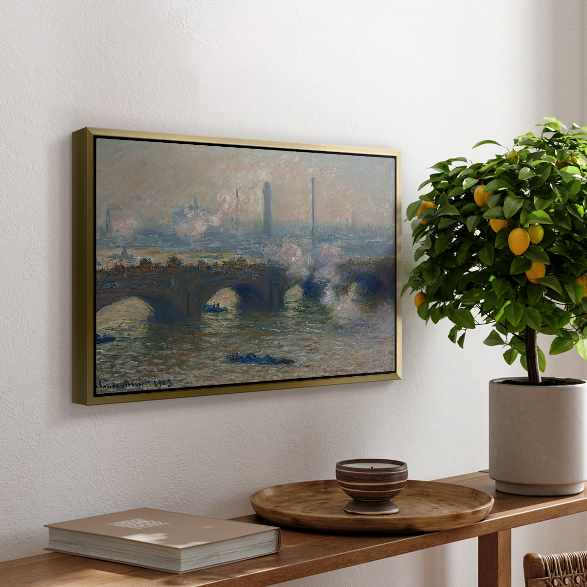 Waterloo Bridge, Gray Day, 1903 by Claude Monet, presented in a gold floater framed canvas featuring a muted cityscape of bridge spanning river under overcast sky, displayed above a hallway console table.